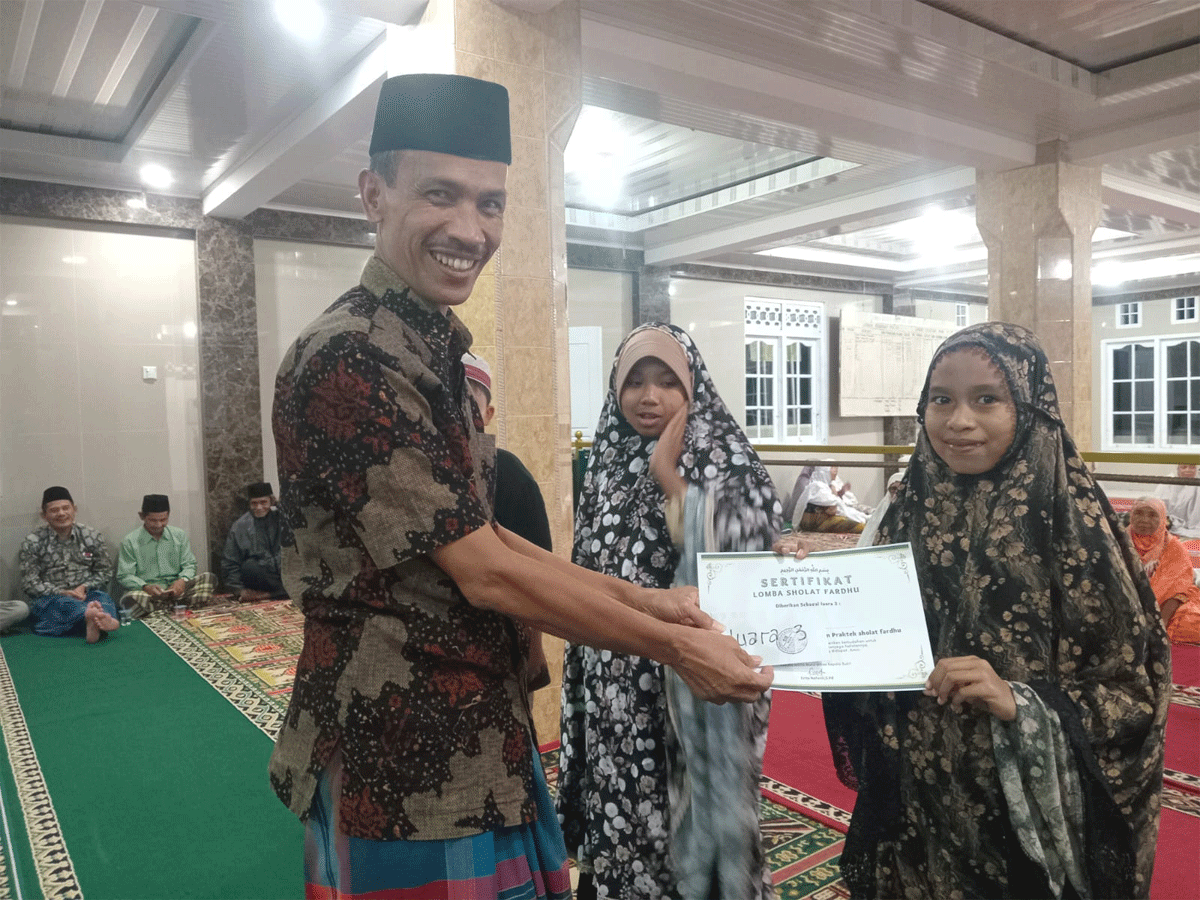 Wakil Bupati Solok Selatan, Yulian Efi serahkan dan piagam kepada siswa MDTA Masjid Nurul Ikhlas Kepala Bukit, Adibah Fakhira Jufri.